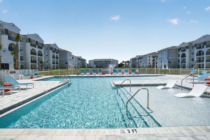 Swimming pool framed by residential buildings at Entrada Apartments, Cape Coral