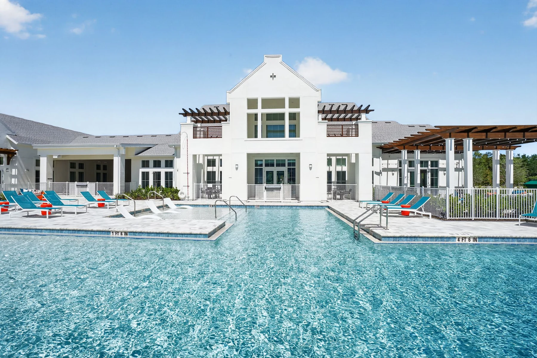 Clubhouse exterior viewed across the pool at Entrada Apartments, Cape Coral