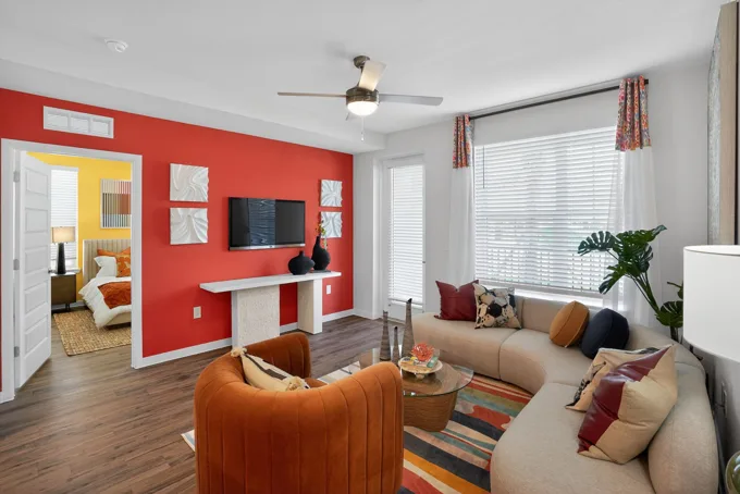Apartment living room with red accent wall at Entrada Apartments, Cape Coral