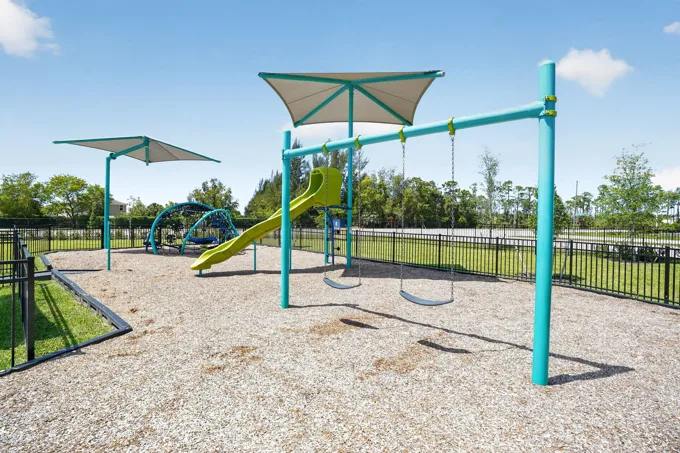 Outdoor playground with shade canopies at Entrada Apartments, Cape Coral