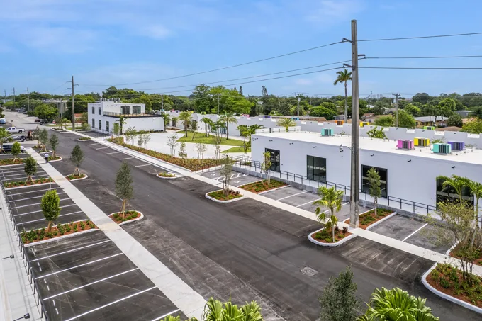 Daytime view of commercial buildings and landscaping at Thrive Art District, Fort Lauderdale