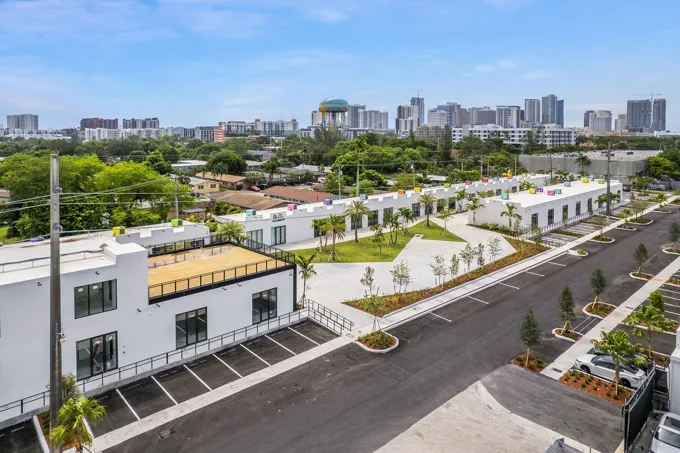 Elevated view of storefronts and the Fort Lauderdale skyline at Thrive Art District, Fort Lauderdale