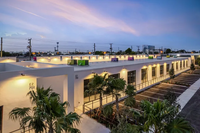 Illuminated commercial building exterior at dusk at Thrive Art District, Fort Lauderdale