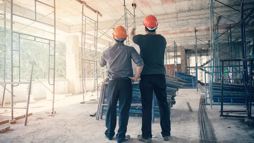 Construction professionals reviewing work inside an active building site
